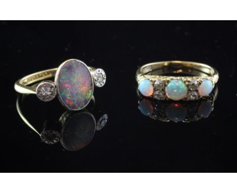 An early 20th century 18ct gold and platinum, black opal and two stone diamond ring, size L, together with an 18ct gold, whit