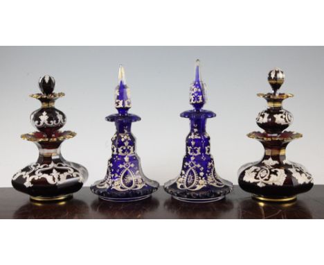 A pair of unusual Bohemian ruby glass 'double' scent bottles, late 19th century, of squat baluster form overlaid with white e