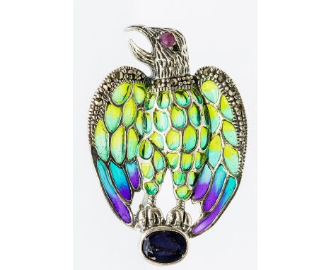 A plique a jour silver and enamel pendant/brooch in the form of an eagle, cabochon ruby set eye and marcasite details, the cl