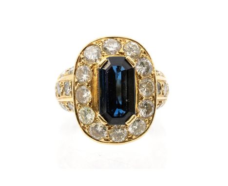 A sapphire and diamond 18ct gold cluster ring, the claw set elongated emerald cut sapphire, weight approx. 1.9carats, within 