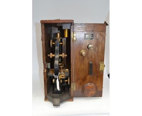 A Broadhurst Clarkson boxed microscope, early 20th Century fitted in an oak case, the microscope inscribed R&amp;J Beck, stam
