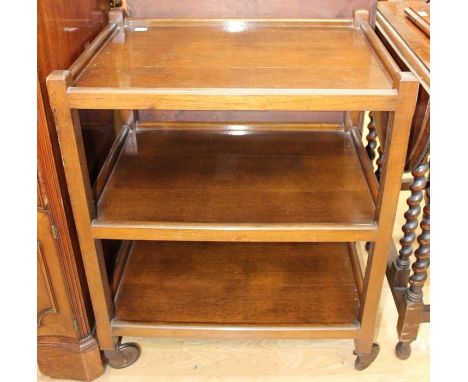 A collection of furniture, comprising a three tier oak tea trolley, an early 20th Century oak gateleg table, a 1930s bureau w