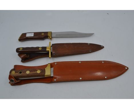 &nbsp;Three recent Bowie type fixed blade knives, the first by Bora with wood grips, the 7" blade engraved with stag hunting 