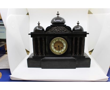 A late 19th century slate mantle clock, Eight day movement, the face with a chapter dial and Arabic numerals, Each side with 