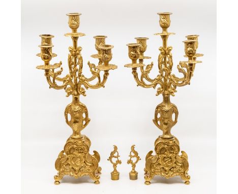 A Rococo style brass garniture clock set, comprising an eight day mantle clock and a pair of four branch candelabra, raised o