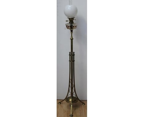 An Arts and Crafts brass standard oil lamp, with cut glass reservoir, opaline glass shade, clear glass funnel, 165cm high