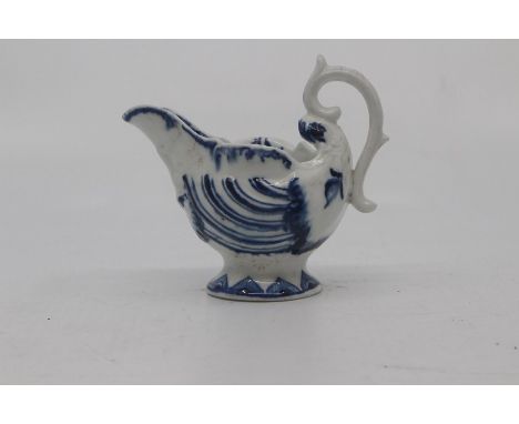 A Worcester 'Dolphin Ewer' cream boat, circa 1770, painted in blue with details and borders, 8cm high.Condition: Tiny firing 