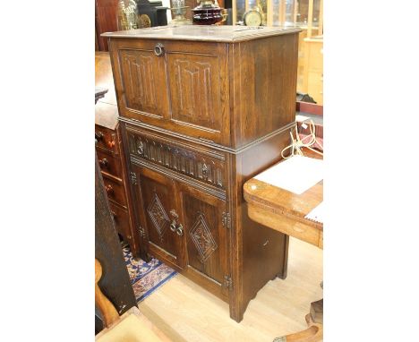 A 1970's old charm oak drinks cabinet along with a 1950's mantle clock , Cabinet Dimensions Height 124cm, Width 75cm, Depth 4