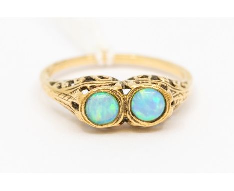 An opal and 9ct gold ring, comprising  two round opals and scroll mount, size m1/2, total gross weight approx 2gms Condition 