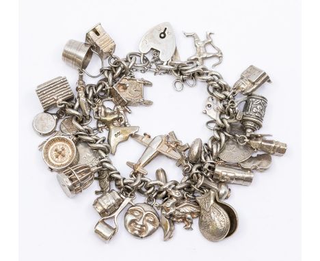 A sterling silver charm bracelet, fitted with approx 30 charms, including an Elizabethan coin, mostly 925 silver, some charms