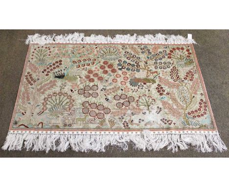 A Chinese Silk Rug, the ivory field of birds, animals and plants enclosed by arrow head borders, 156cm by 96cm