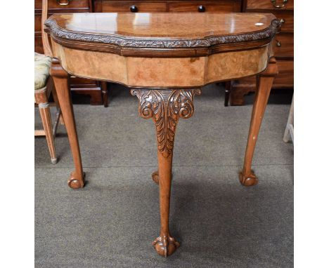 A Reproduction Cross-Banded Burr Walnut Fold Over Card Table, with shaped front, raised on ball and claw feet, 85cm by 44cm b