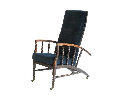 An Arts &amp; Crafts Stained Beech Reclining Armchair, slatted back, the arms supported by bobbin supports, slatted base, bob