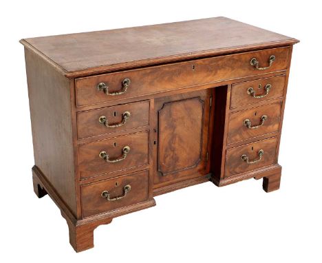 A George III Mahogany Kneehole Dressing Table, late 18th century, the moulded top above a long frieze fitted with compartment