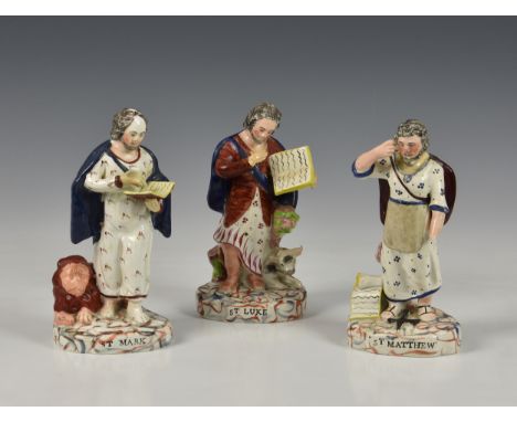 Three early 19th century pearlware Staffordshire figures of saintsdepicting St. Mark, St. Luke and St. Matthew, each on an ov