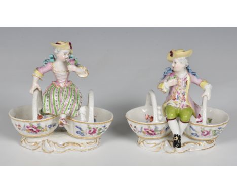 A pair of Meissen style porcelain figural salts 20th century, in the form of a boy and girl, in 18th century costume and each