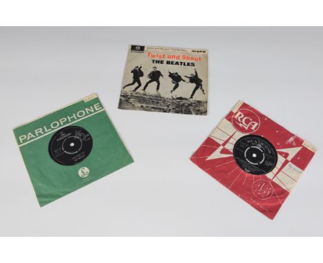 Two Beatles Seven inch single vinyl records including ‘Twist and Shout’ and ‘She Loves You’ along with an Elvis Presley 7in s