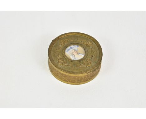 A circular embossed gilt brass lidded jewellery box late 19th / early 20th century, the lid with head and shoulders portrait 