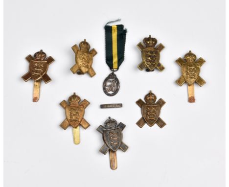 Assorted Jersey Militia cap badges with a Jersey Militia dress medal and seven badges. * Provenance: R &amp; D Auctions Ltd, 