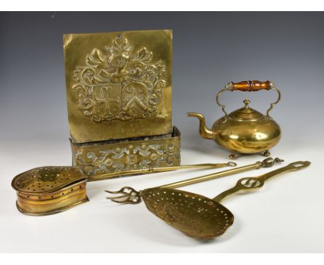 A small collection of antique brasswareto include a brass wall hanging heraldic arms / armorial candle box or tray; brass tea