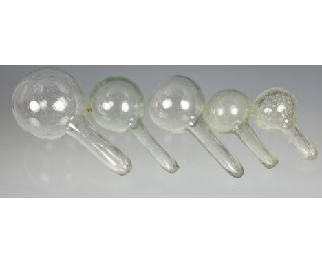 Four blown glass plant watering globes or bottle stoppers probably 19th / early 20th century, in green tinted clear glass, wi