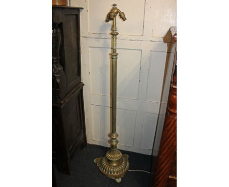 A brass column adjustable standard lamp on circular reeded base