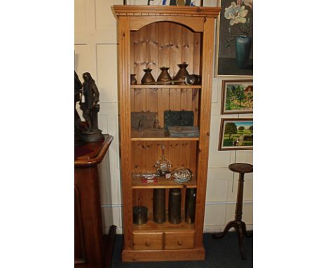 A modern pine narrow four-shelf bookcase with two small drawers, on plinth base, 66cm