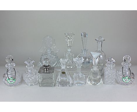 A collection of twelve glass scent bottles, including a pair with enamel labels 'Benzoin Lotion' and 'Lavender Water' another