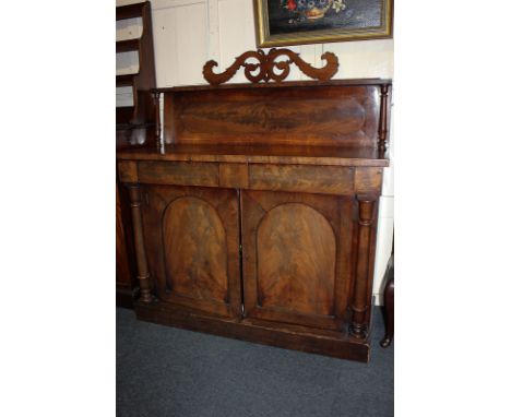 A Victorian mahogany chiffonier, the raised back with pierced scroll surmount and rectangular shelf, the flat fronted base wi