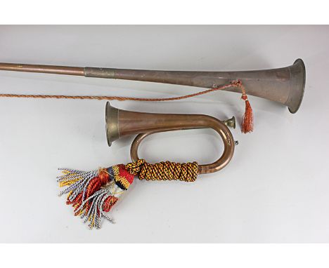 A copper and brass bugle, with cloth cords, 23.5cm, and a hunting horn, 96.5cm