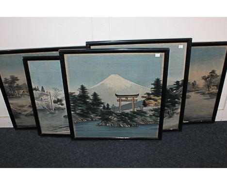 A set of five Japanese needlework tapestry pictures depicting landscapes including buildings by a river, a tower with Mount F