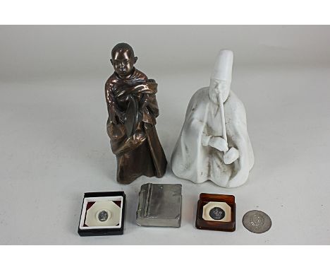 A Veronese bronzed resin figure of a child in robes with two cymbals, a porcelain figure of a man with a pipe, two seals, and