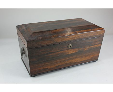 A 19th century rosewood tea caddy, with brass lion mask ring handles, the interior with two lidded canisters and associated g