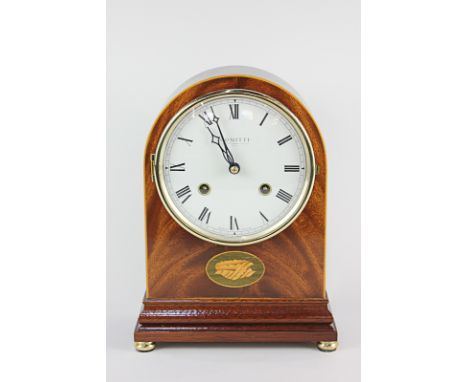 A Comitti Regency style arch top mahogany mantle clock, the eight day movement half striking on a bell, inlaid with shell mar