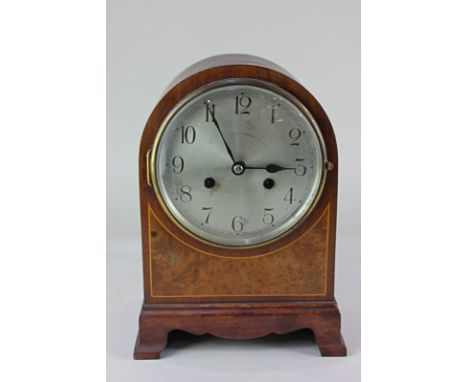 A 20th century mahogany domed cased mantle clock, with burr wood inlay, the circular silverised dial, with Arabic numerals, t