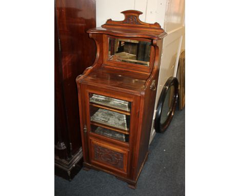 A Victorian glazed music cabinet, raised shelf back with mirror, above glazed door enclosing shelves (later adaptations)