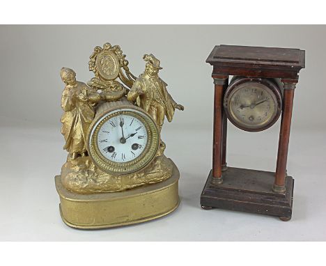 A gold painted figural mantel clock, the drum shaped case flanked a lady and a gentleman, the enamel dial with Roman numerals