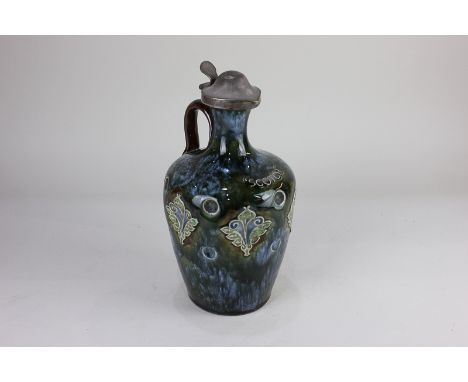 A Doulton Lambeth stoneware Scotch whisky decanter, possibly by Rosina Brown, with plated lid and cork stopper, the dimpled b