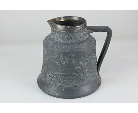A silver mounted tavern jug, decorated in light relief with a continuous scene beneath tubeline script 'The Bell Edmonton The