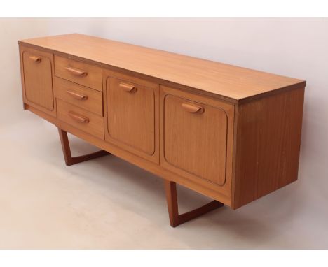 A vintage Stateroom teak sideboard by Stonehill Furniture Ltd - c.1974, with three drawers flanked by a cocktail cabinet with