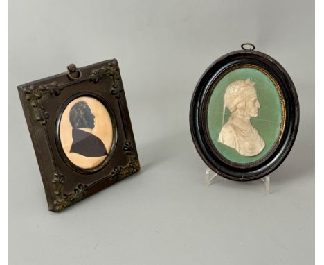 A late Georgian portrait miniature silhouette of a gentleman on card - oval, with gilt highlighted hair, in original pressed 