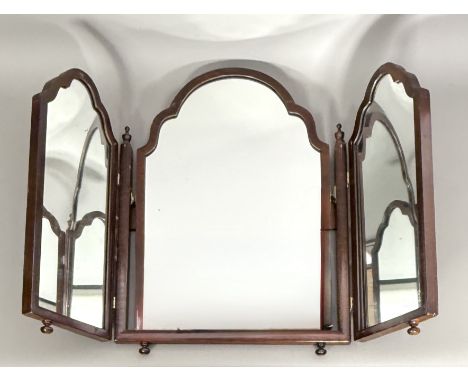 A mid-20th century mahogany triple fold dressing table mirror in the Georgian style - with three shaped arched plates, on tur