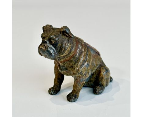 A cold-painted lead pin cushion in the form of a seated Bulldog - early 20th century, 5.9cm high.