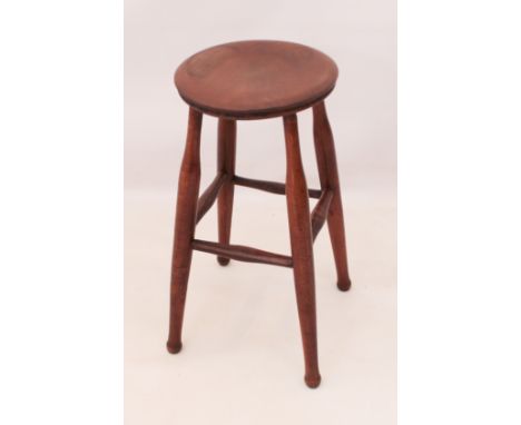 A beech and elm stool - late 19th century, the elm seat on turned supports with peripheral stretchers, 30.5cm diameter, 61cm 