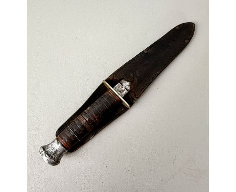 A Fairbairn Sykes style fighting / combat knife in a leather scabbard - stamped 'William Rodgers I Cut My Way' and 'Made in S
