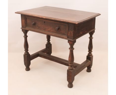 An 18th century oak side table - with single drawer, raised on baluster turned supports united by an H-stretcher. (LWH 84 x 5