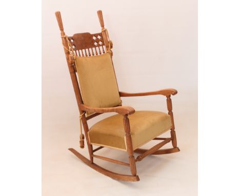A late-19th century maple wood spindle-back rocking chair - the ring-turned back supports with tall reeded handles, the top r