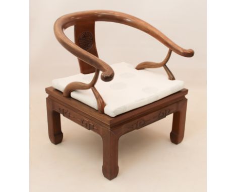 A Chinese hardwood horseshoe-back open armchair - second half 20th century, the splat back with carved Shou symbol, the seat 