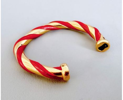 A vintage Herm&egrave;s gold plated and red leather Torsade bangle - stamped 'HERMES', internal size 5.4 x 4.5cm.&nbsp;