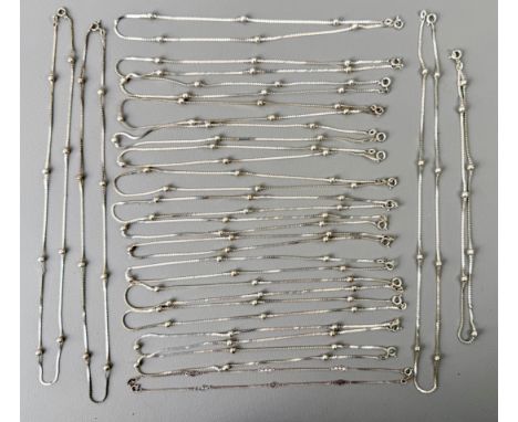 Twenty sterling silver necklaces - comprising 19 x guilloche and ball link necklaces; and a single curb link and pierced bar 